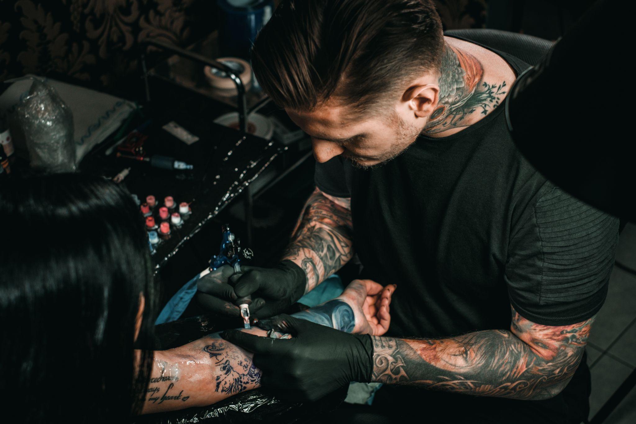 Tattoo artist working on a tattoo