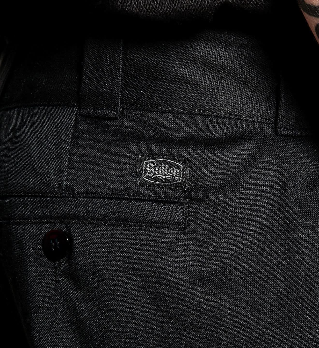 Close-up of a black jacket with a brand label on the chest pocket.
