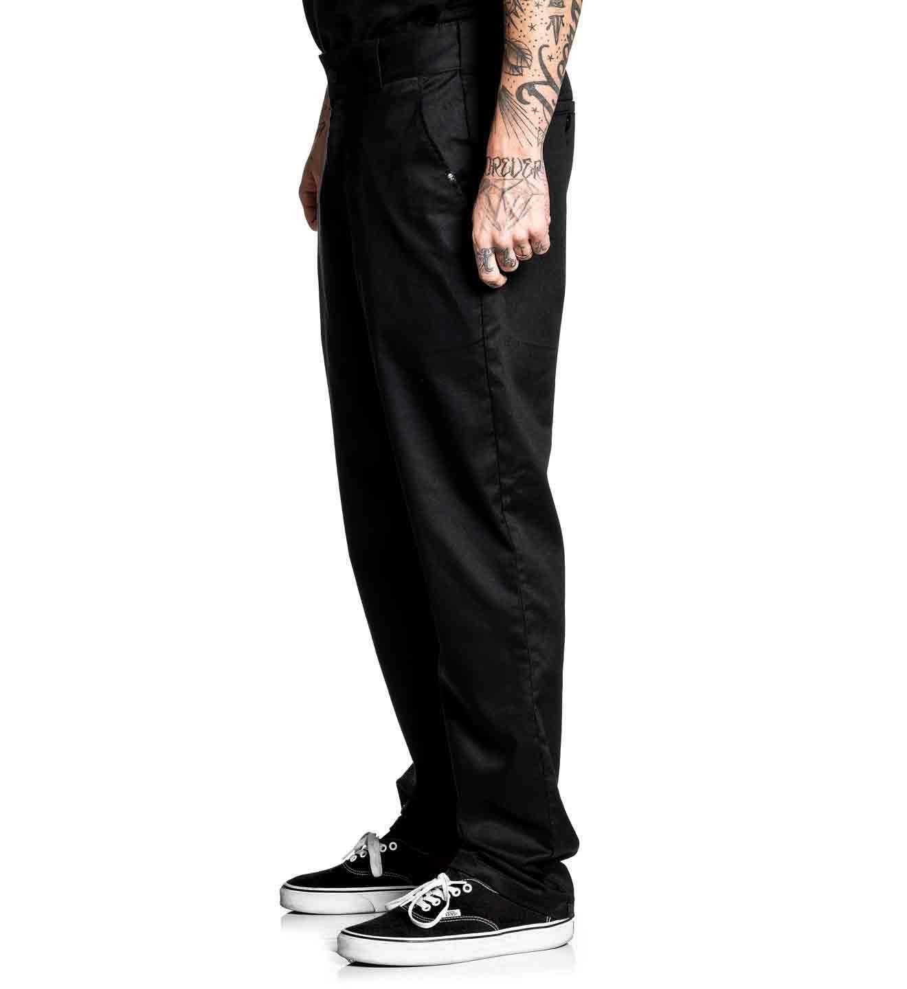 Person wearing black pants and black shoes on a white background