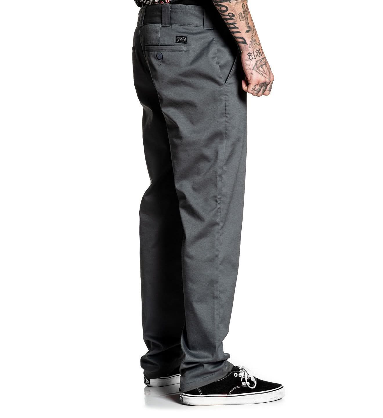 Gray pants worn by a person on a white background