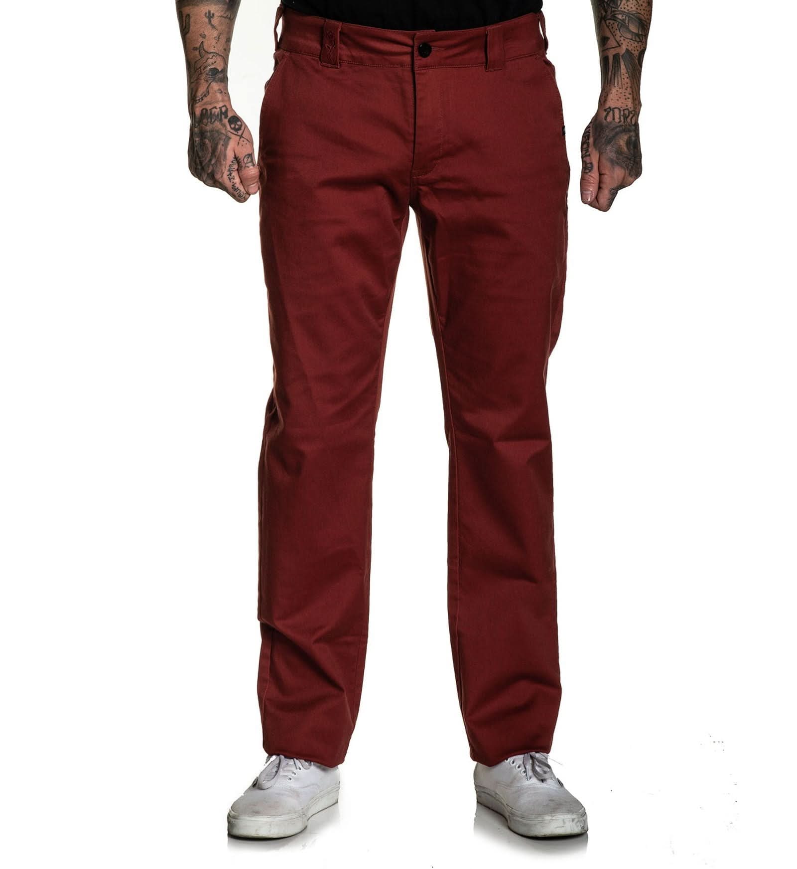 Maroon pants worn by a person on a white background