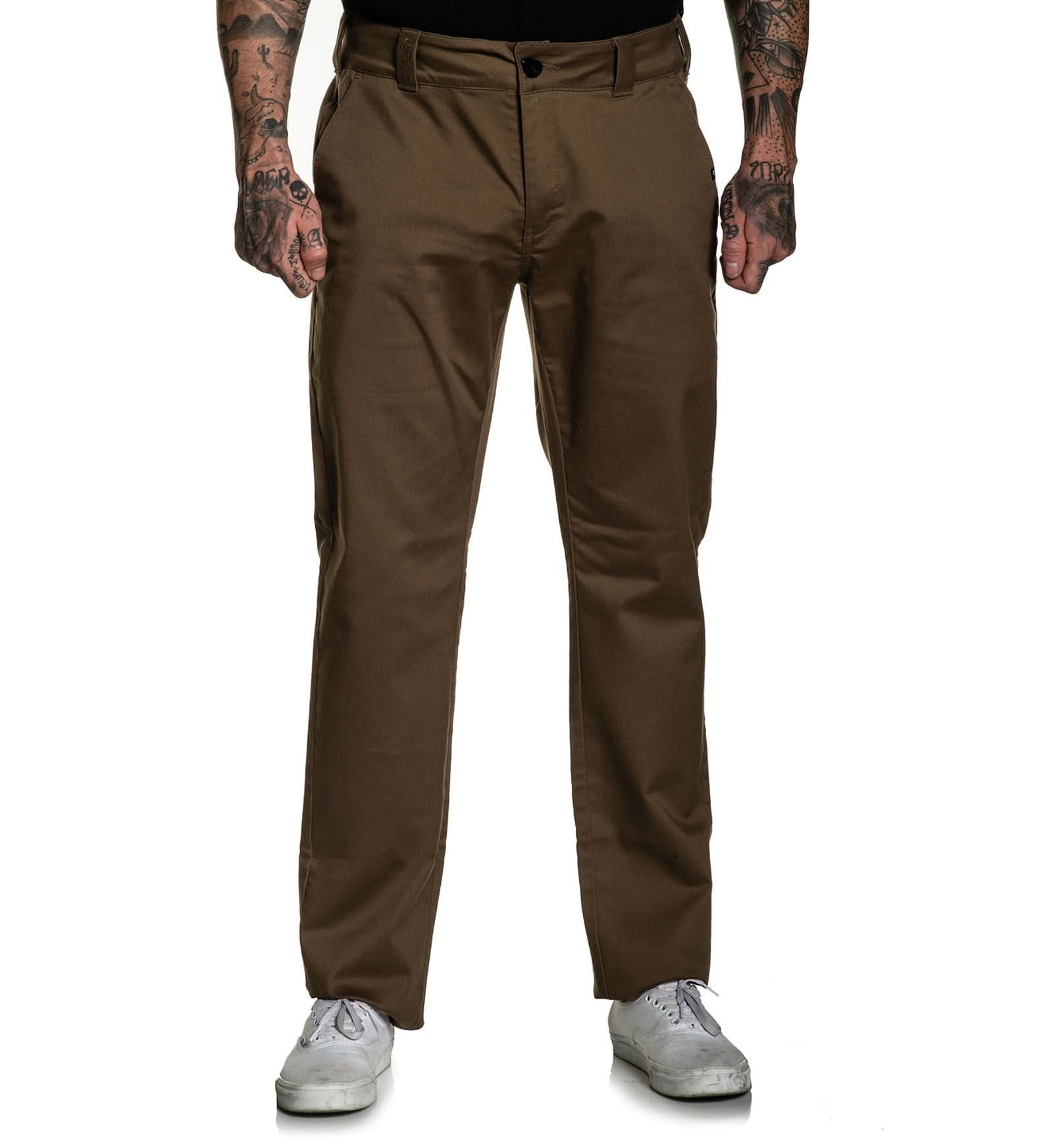 Brown pants worn by a person on a white background