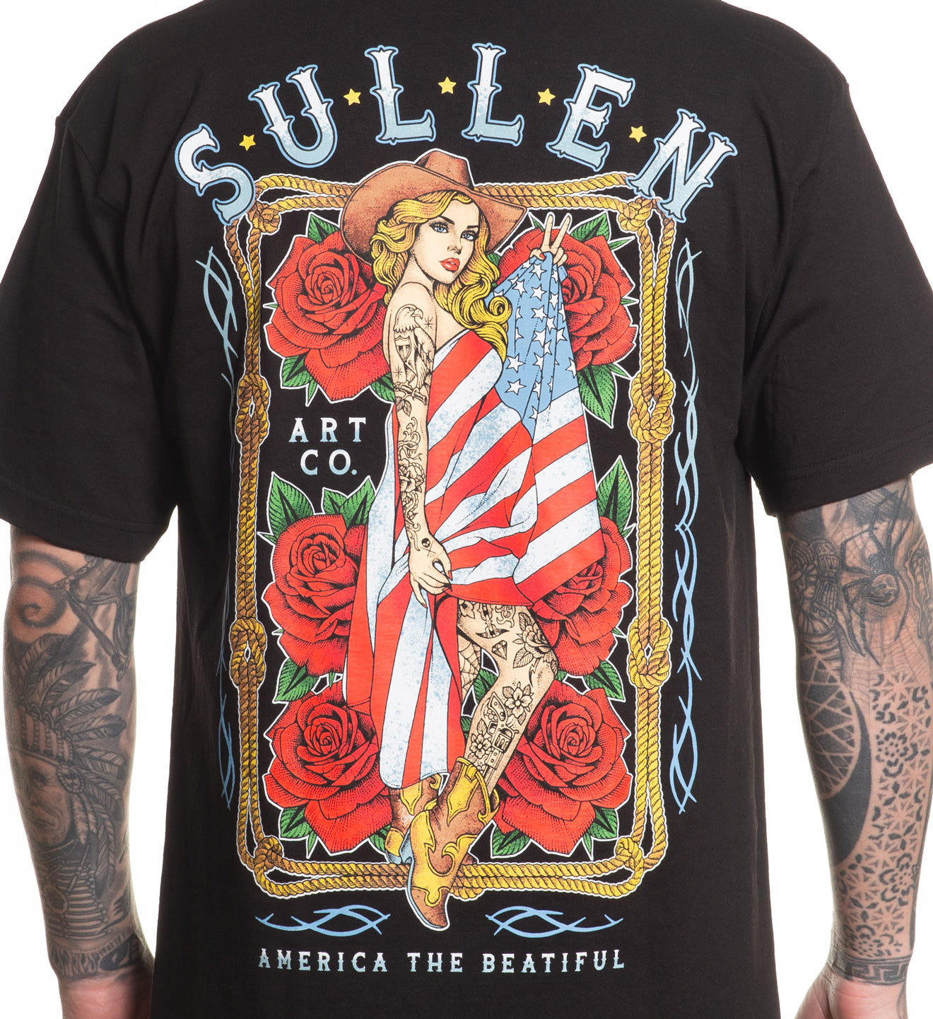 Black t-shirt with a colorful graphic design featuring a woman holding an American flag, surrounded by roses, on a white background.