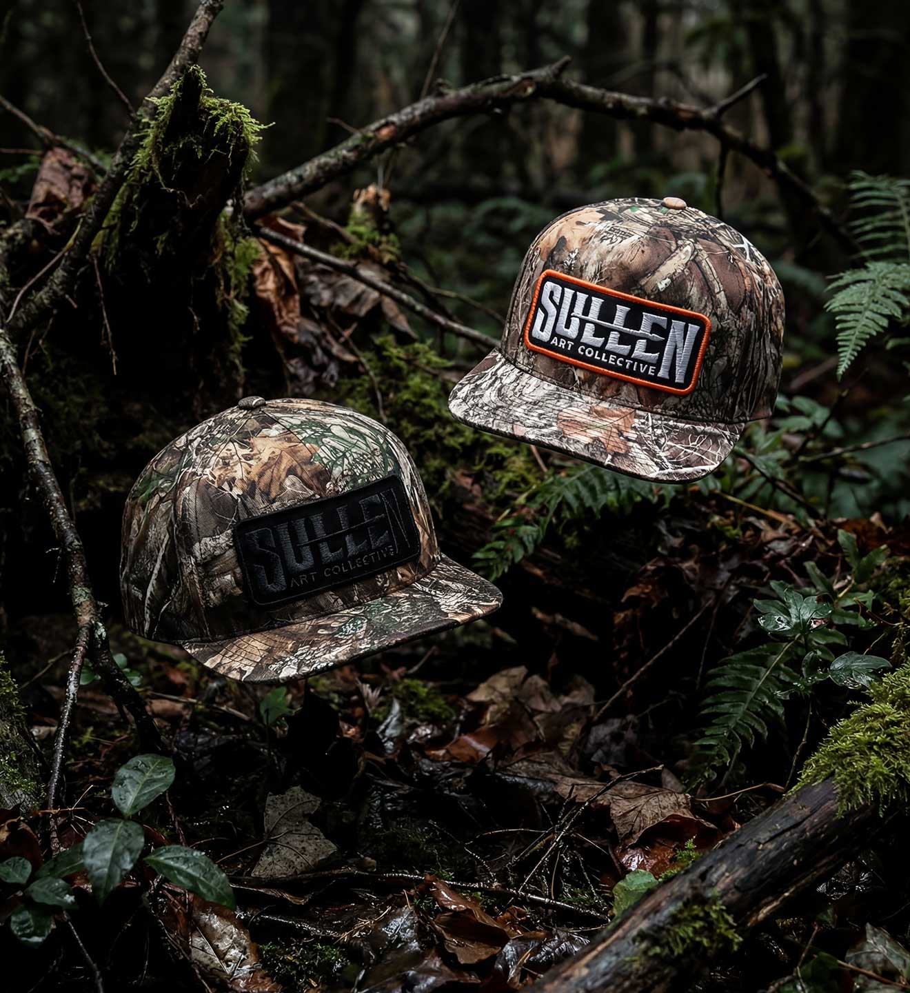 Two camouflage hats with 'Sullen' branding on a forest floor background