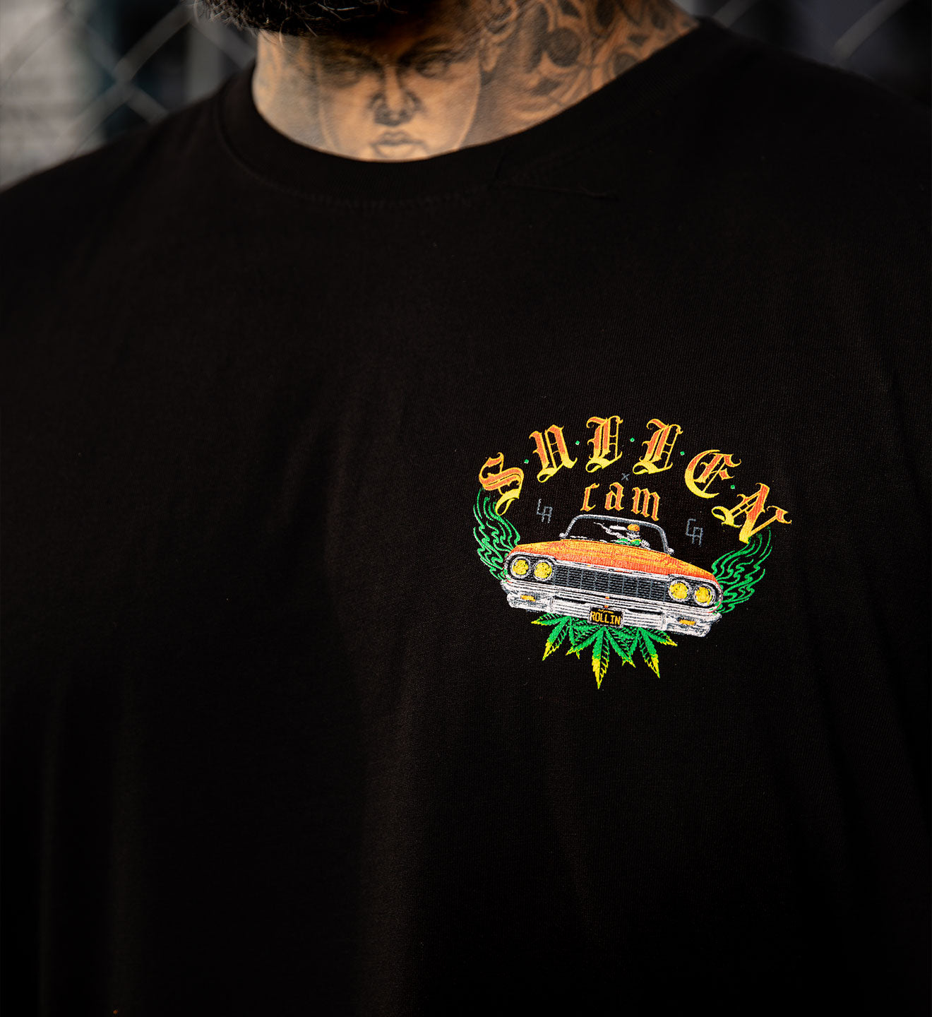 Black t-shirt with a graphic design featuring a car and text on a dark background