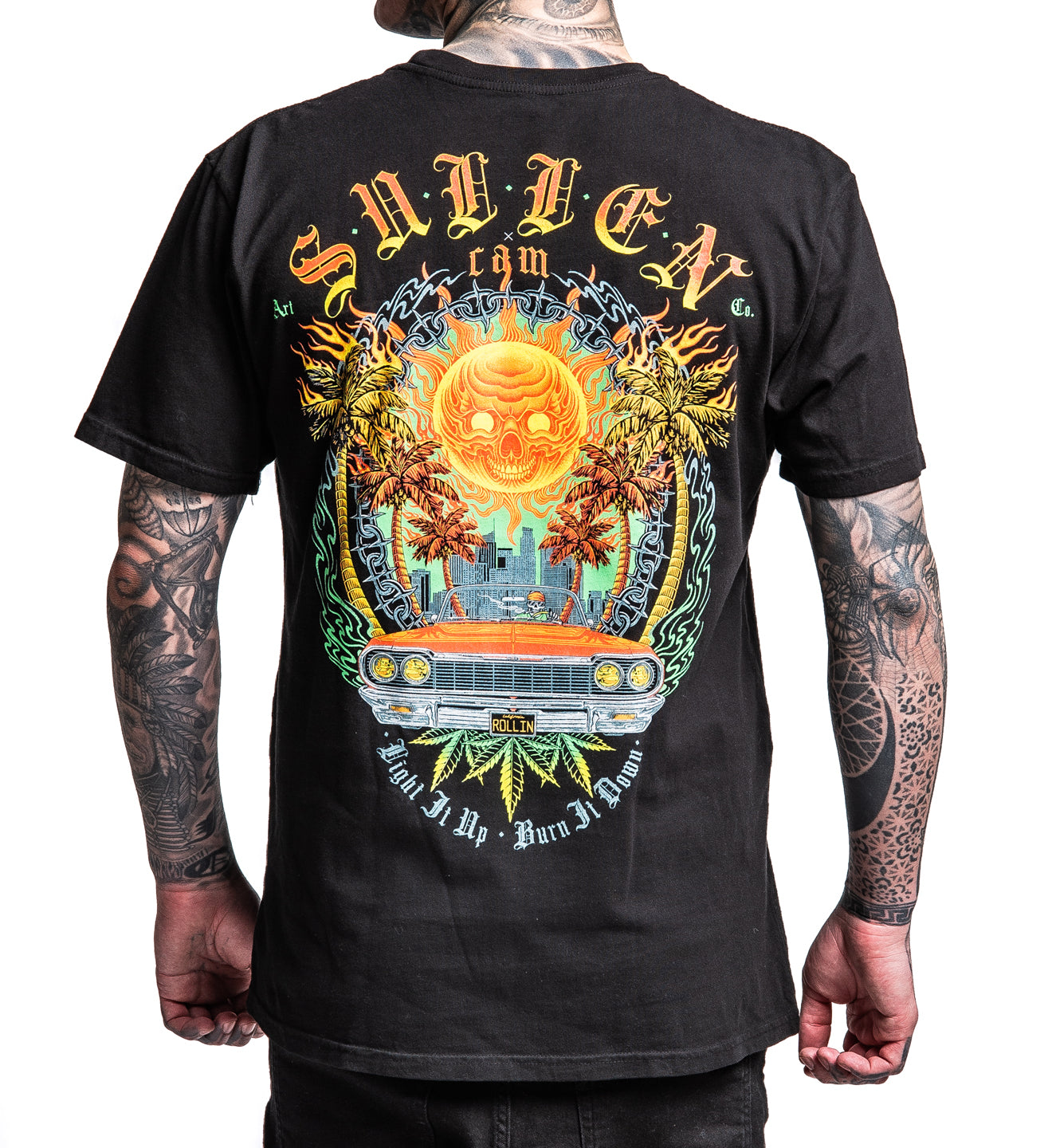 Black t-shirt with colorful graphic design on the back, worn by a person.