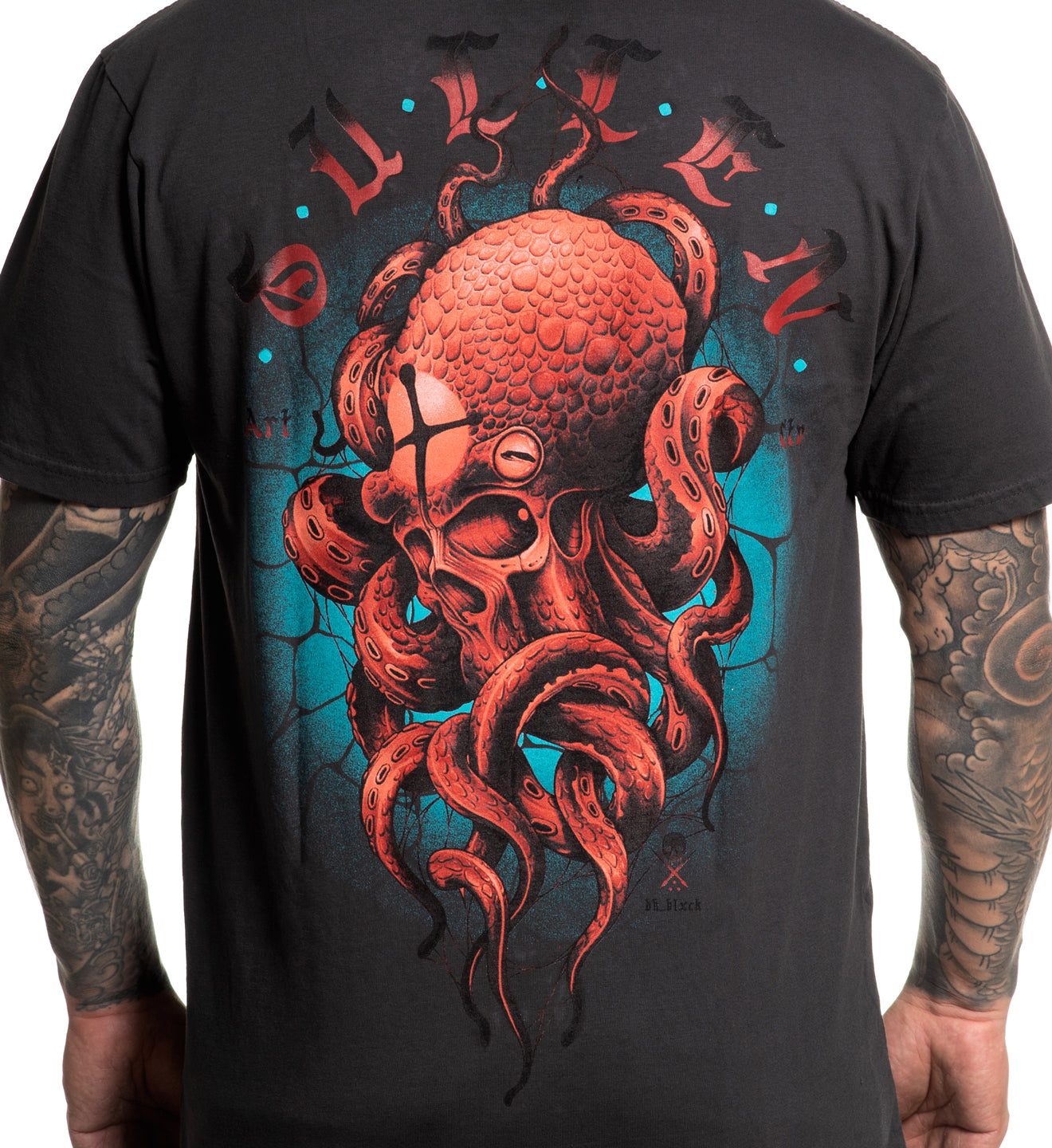 Black t-shirt with a red octopus design on the back, worn by a person with tattoos.