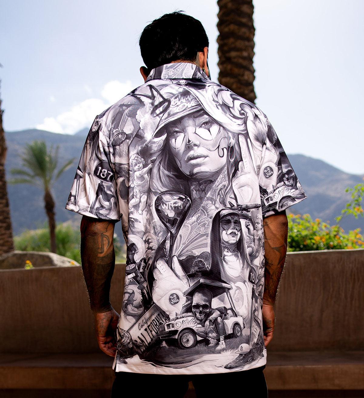 Person wearing a black and white patterned shirt with a scenic background
