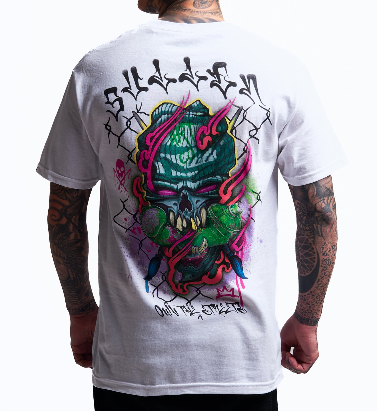 White t-shirt with colorful skull design on the back, worn by a person.