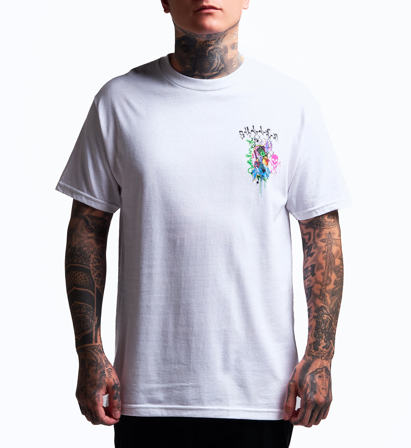 Person wearing a white t-shirt with a colorful graphic design on a plain background