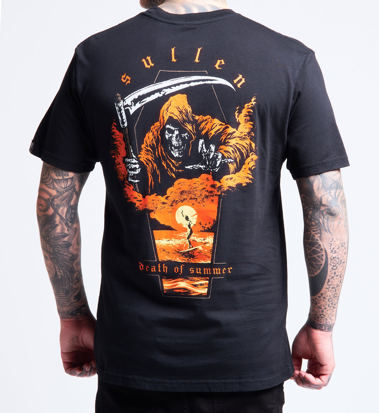 Black t-shirt with a graphic design of a hooded figure holding a scythe and text on the back, worn by a person.