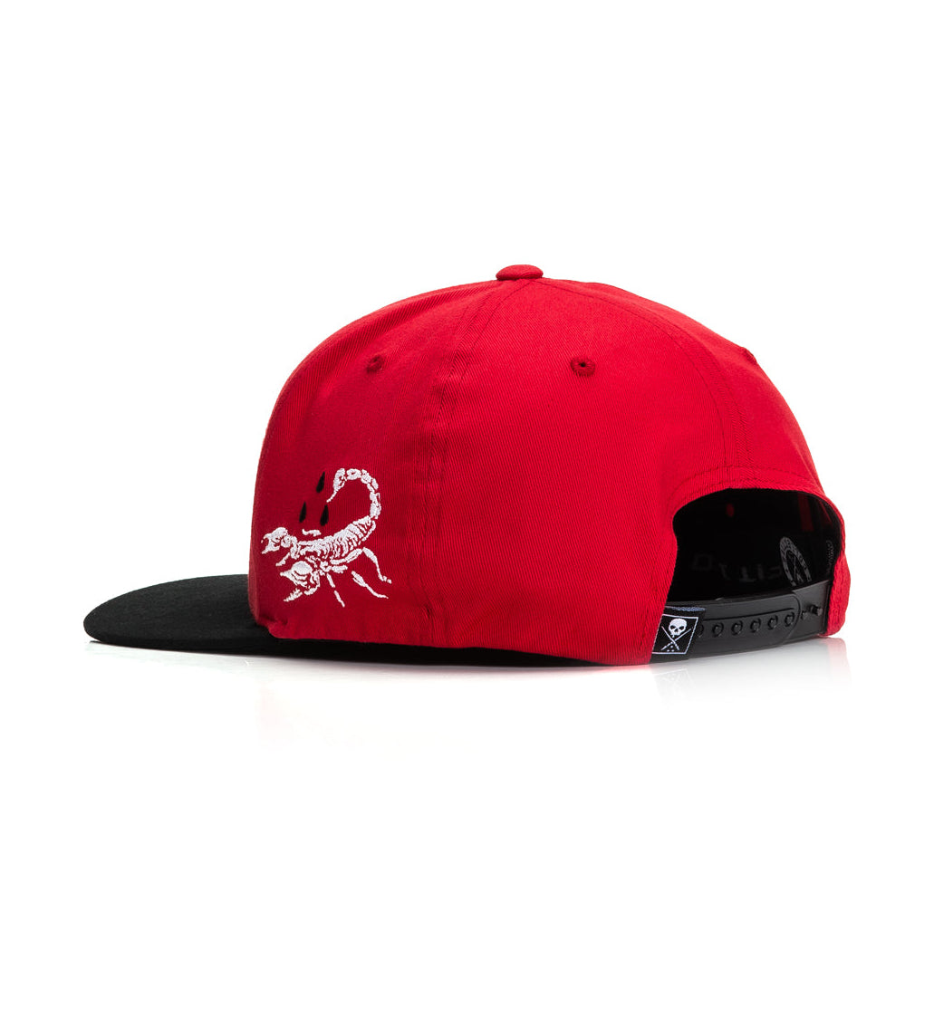Red cap with a white scorpion logo on a white background