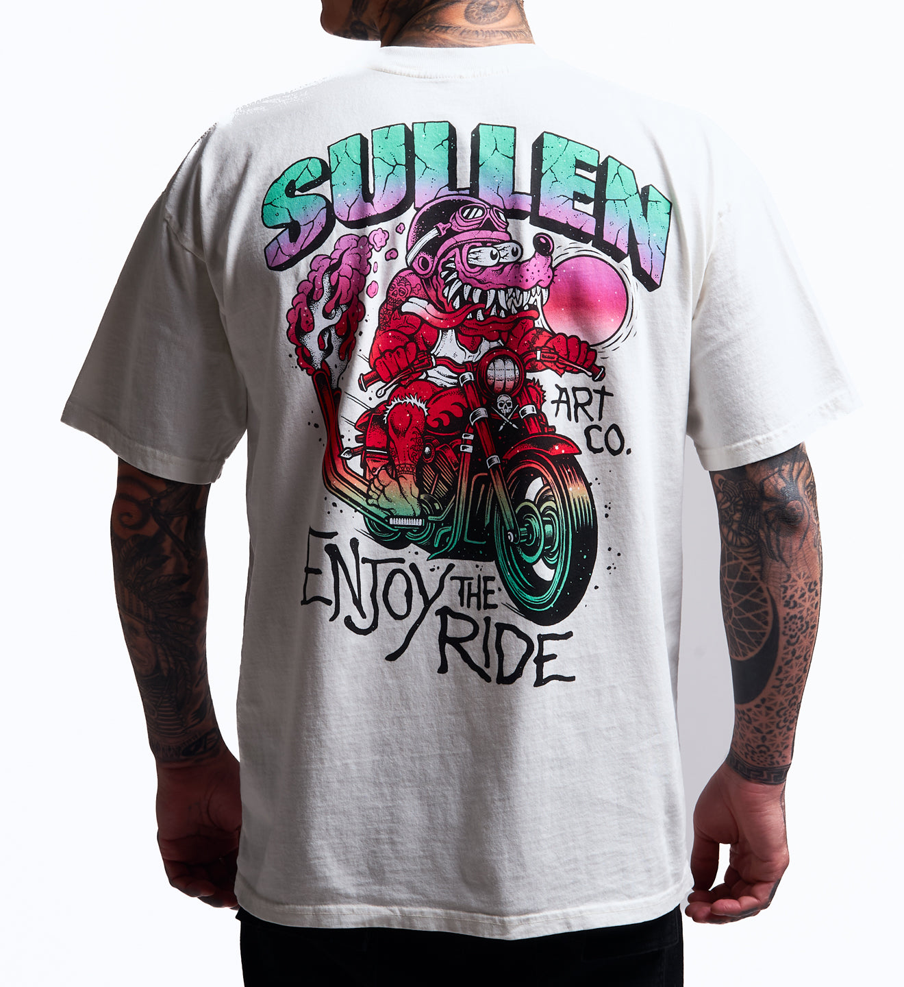 White t-shirt with colorful graphic design and text on the back, worn by a person.