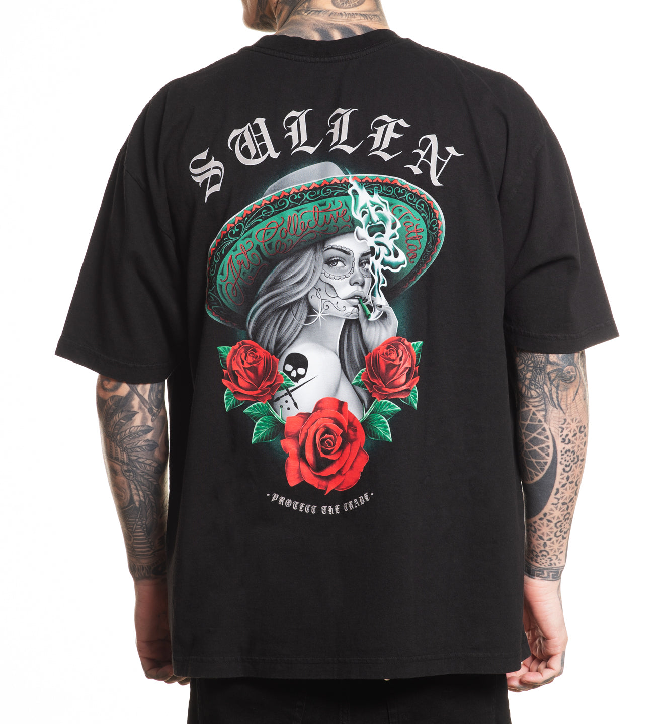 Black t-shirt with a graphic design of a woman in a sombrero with roses and a skull, and the brand 'Sullen' on the back.