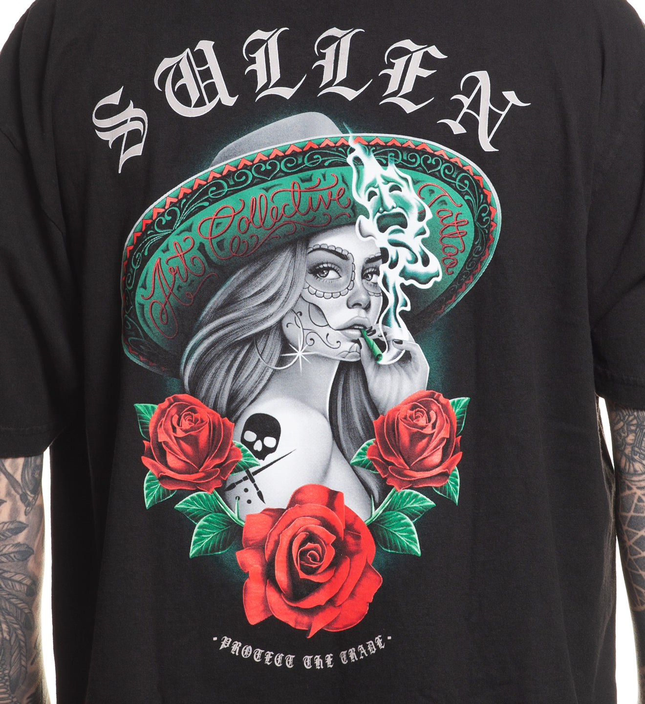Black t-shirt with a graphic design of a woman in a sombrero with roses and text, brand 'Sullen' visible.