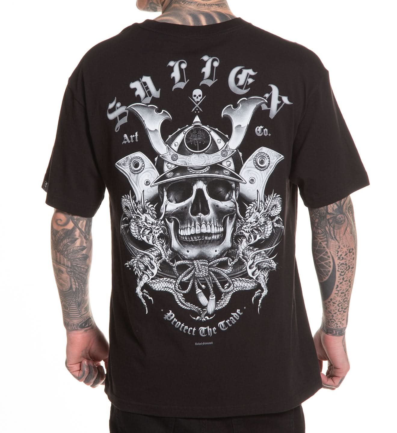 Black t-shirt with a skull and helmet design on the back, worn by a person with tattoos.