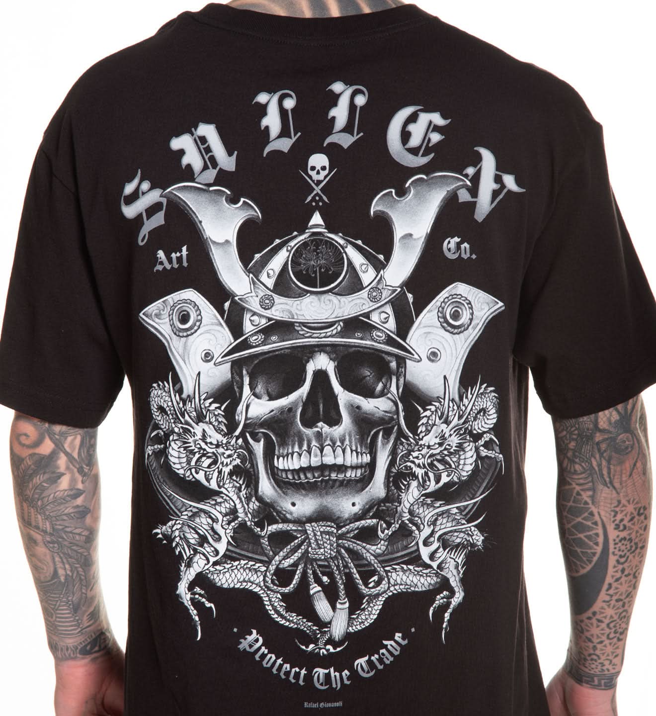 Black t-shirt with a detailed skull and crossbones design on the back, worn by a person with tattoos.