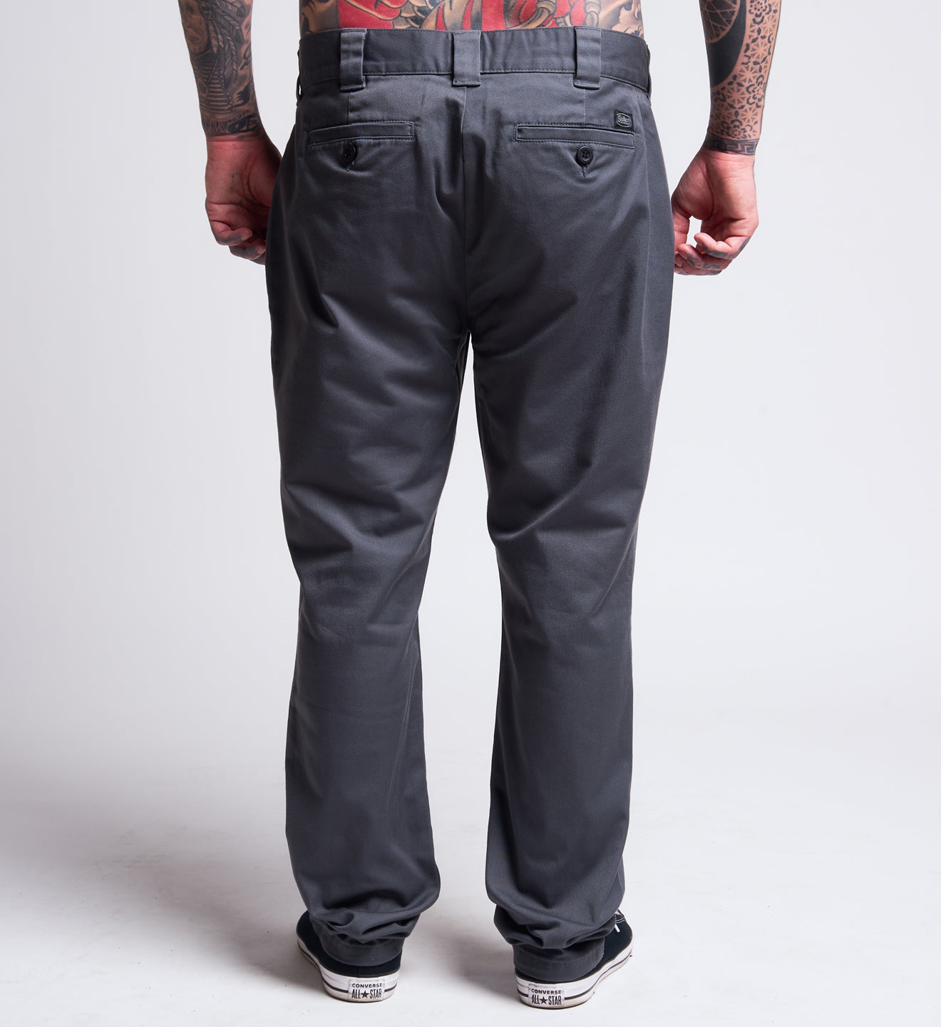 Person wearing gray pants on a plain background