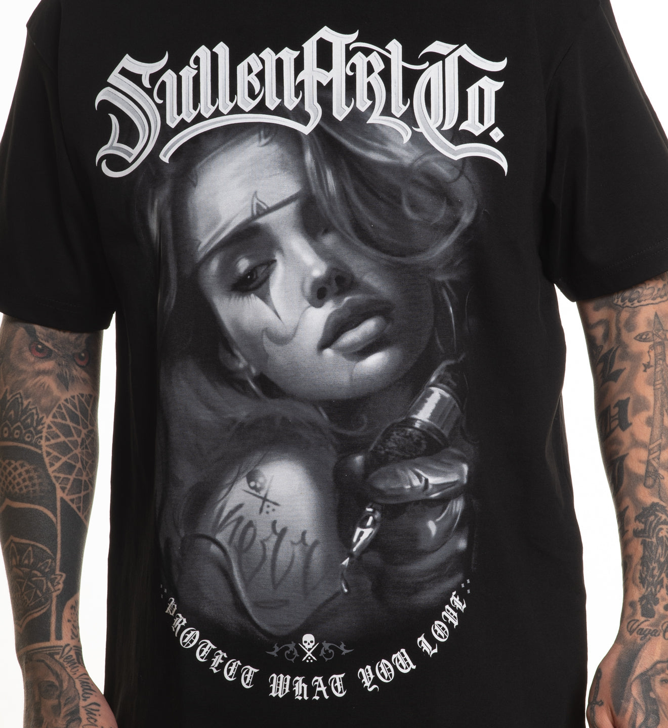 Black t-shirt with a graphic design of a woman's face and tattoos, featuring the text 'Sullen Art Co.'