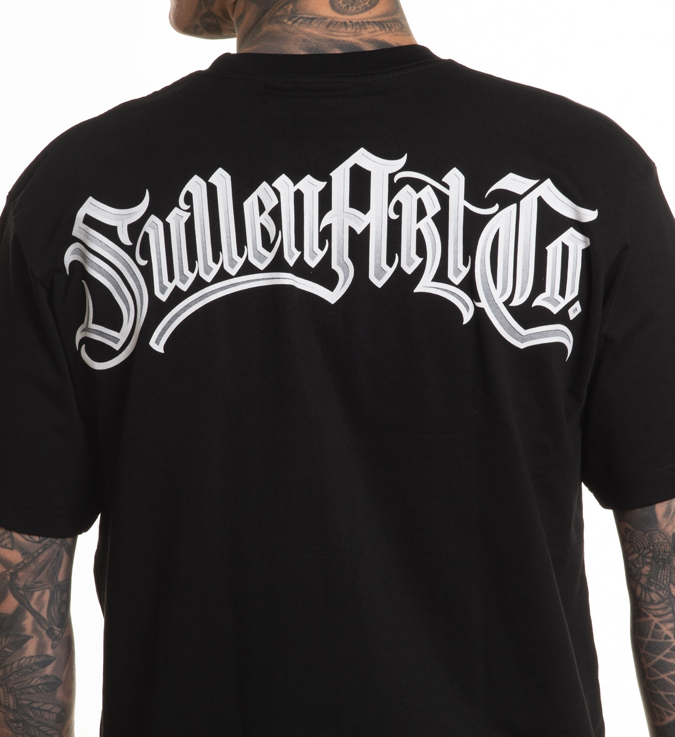 Black t-shirt with 'SuilenArt Co' logo on the back, worn by a person with tattoos.