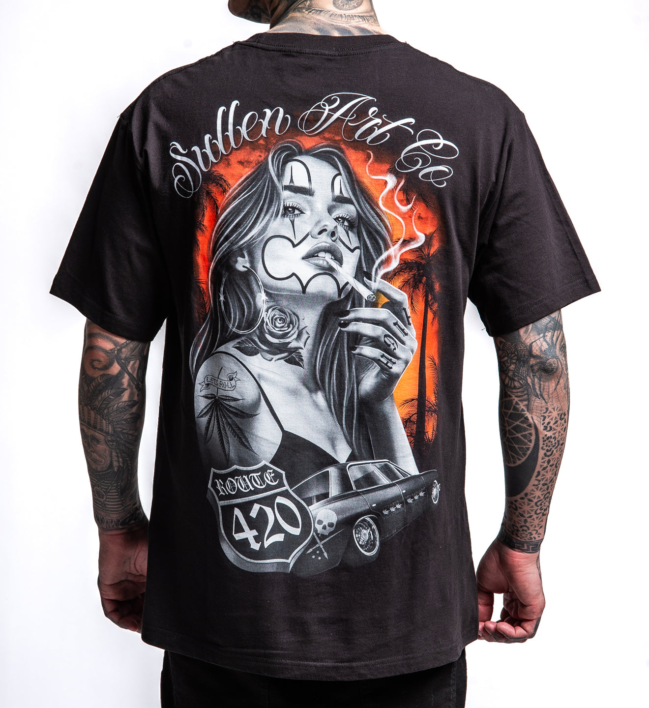 Black t-shirt with a graphic design of a woman smoking and Route 420 text, worn by a person with tattoos.
