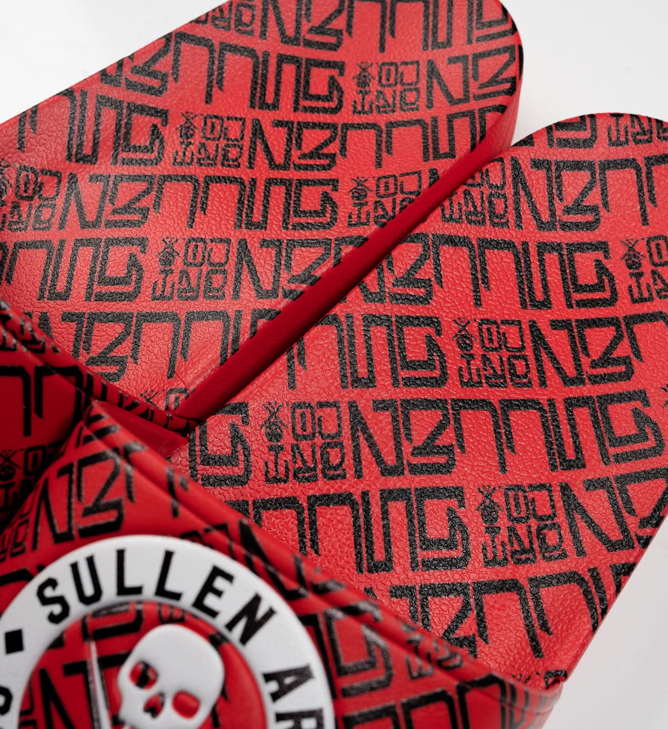 Red dartboard with black text and a skull logo on a white background