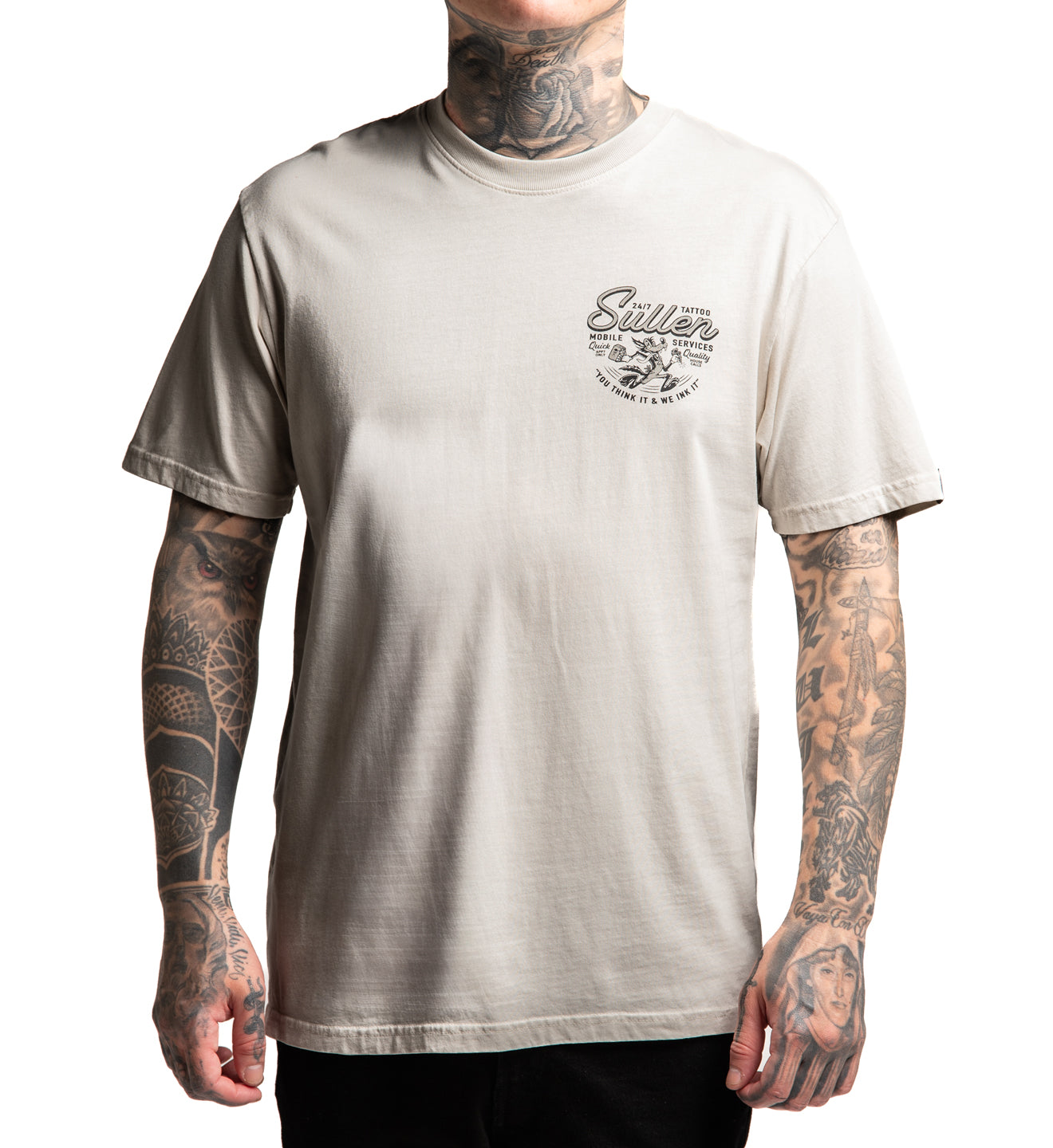 Person wearing a beige t-shirt with a logo and text on a white background