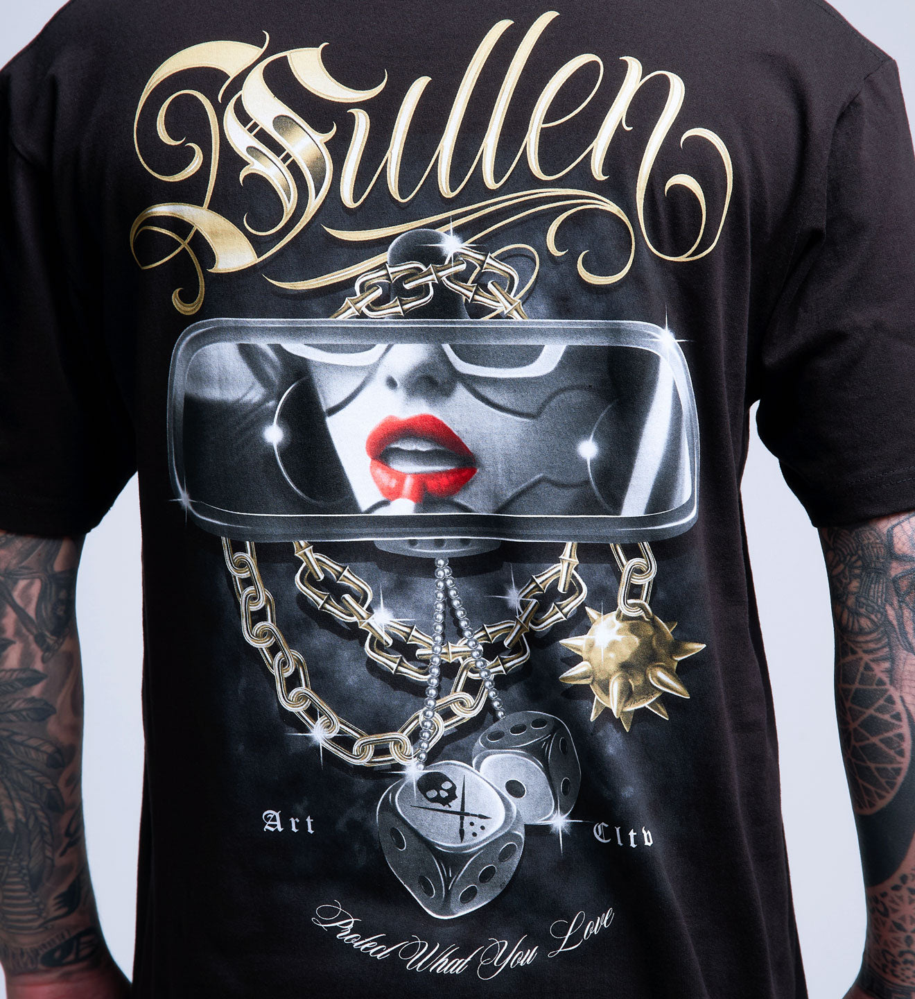Black t-shirt with a graphic design of a face with red lipstick, chains, and text on a white background.