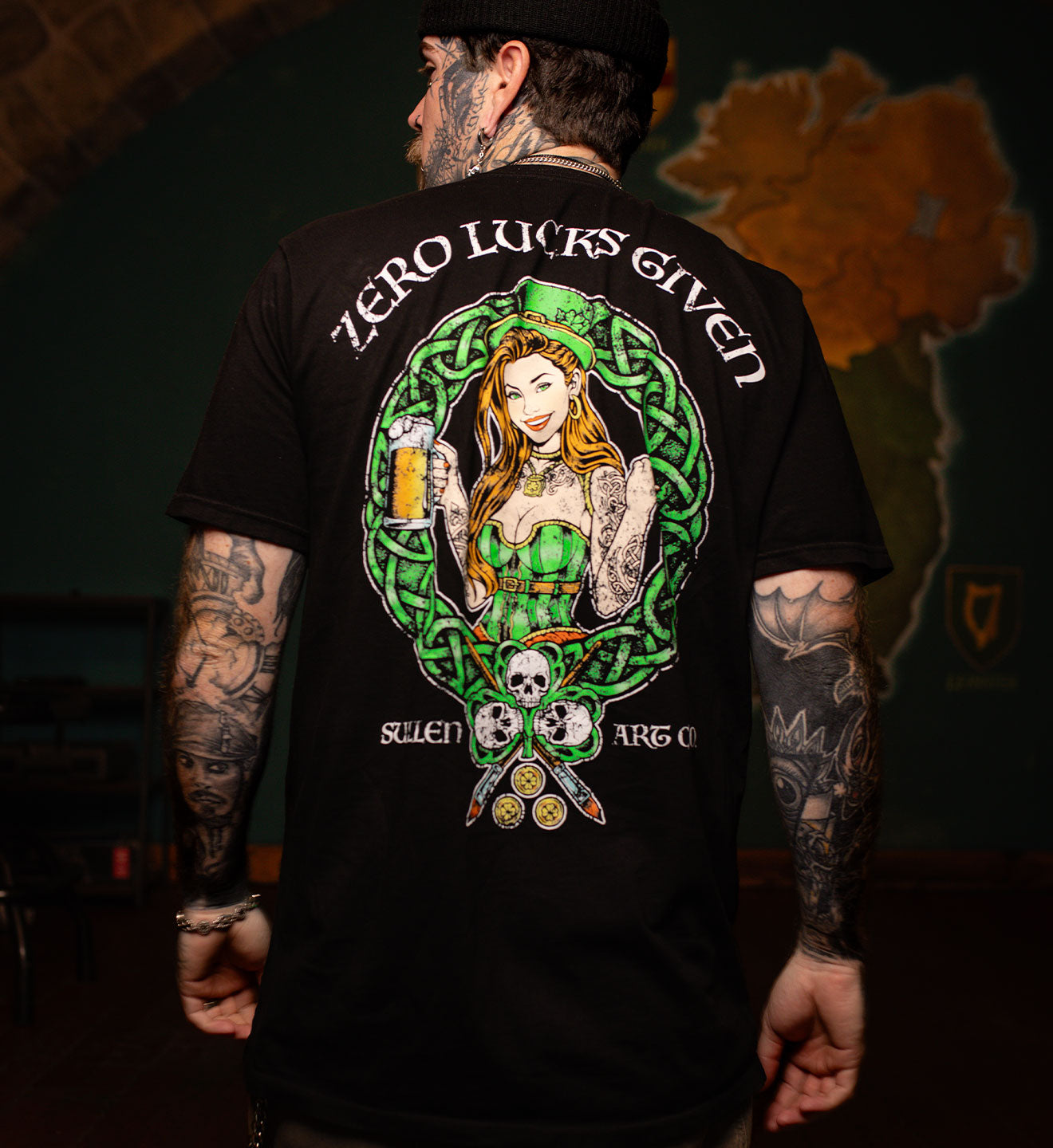 Person wearing a black t-shirt with a colorful graphic design and text.