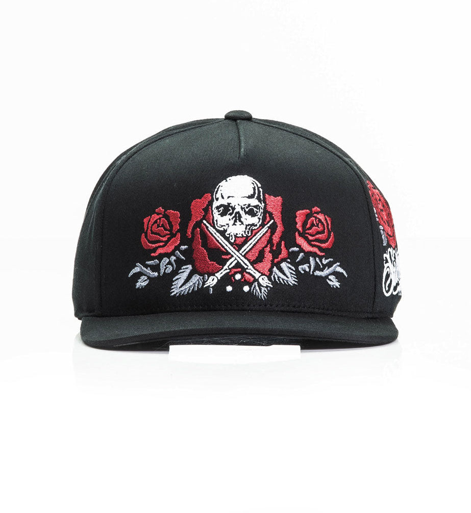 Black cap with skull and roses design on a white background