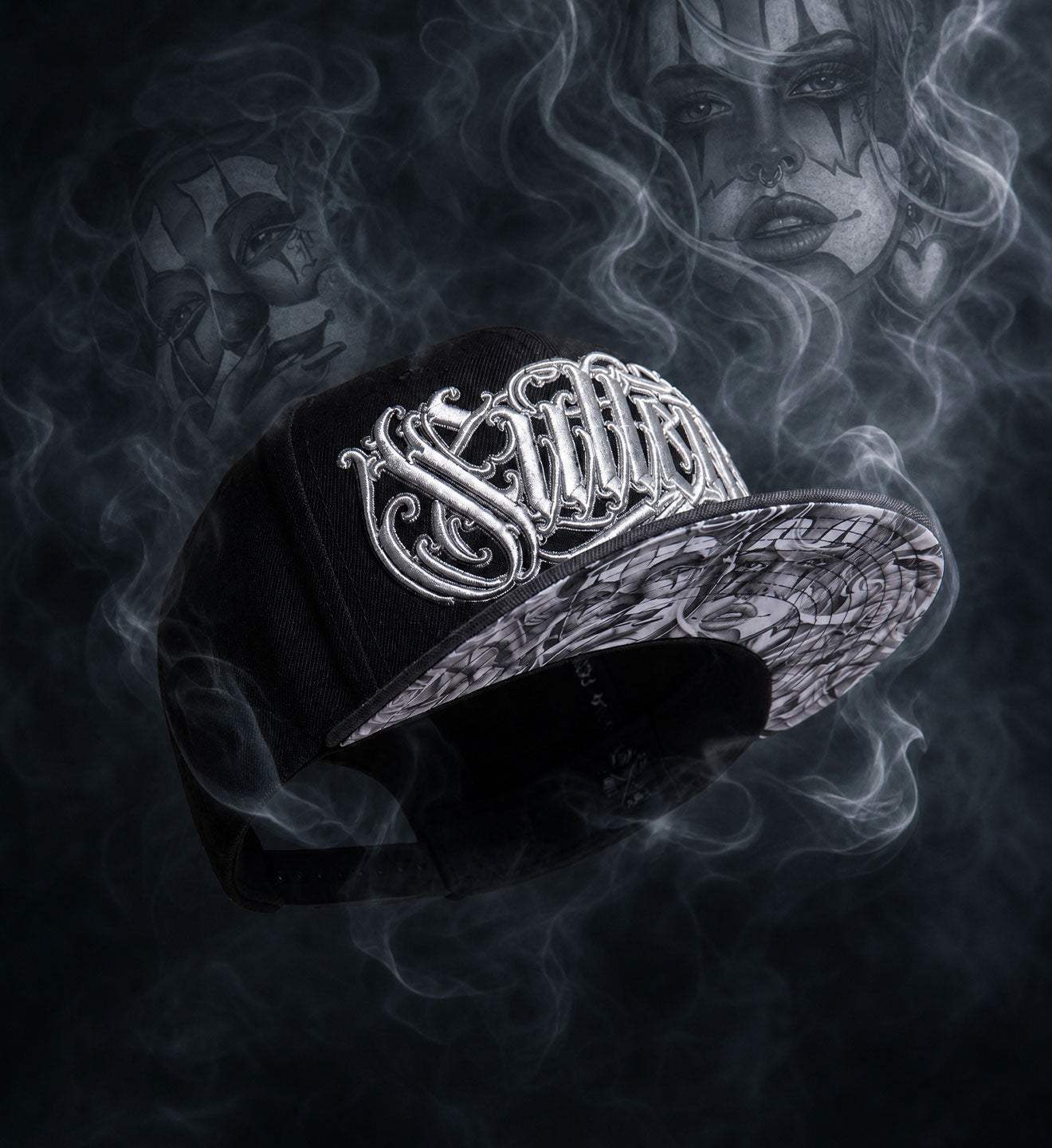 Black cap with white logo on a dark background with smoke effect