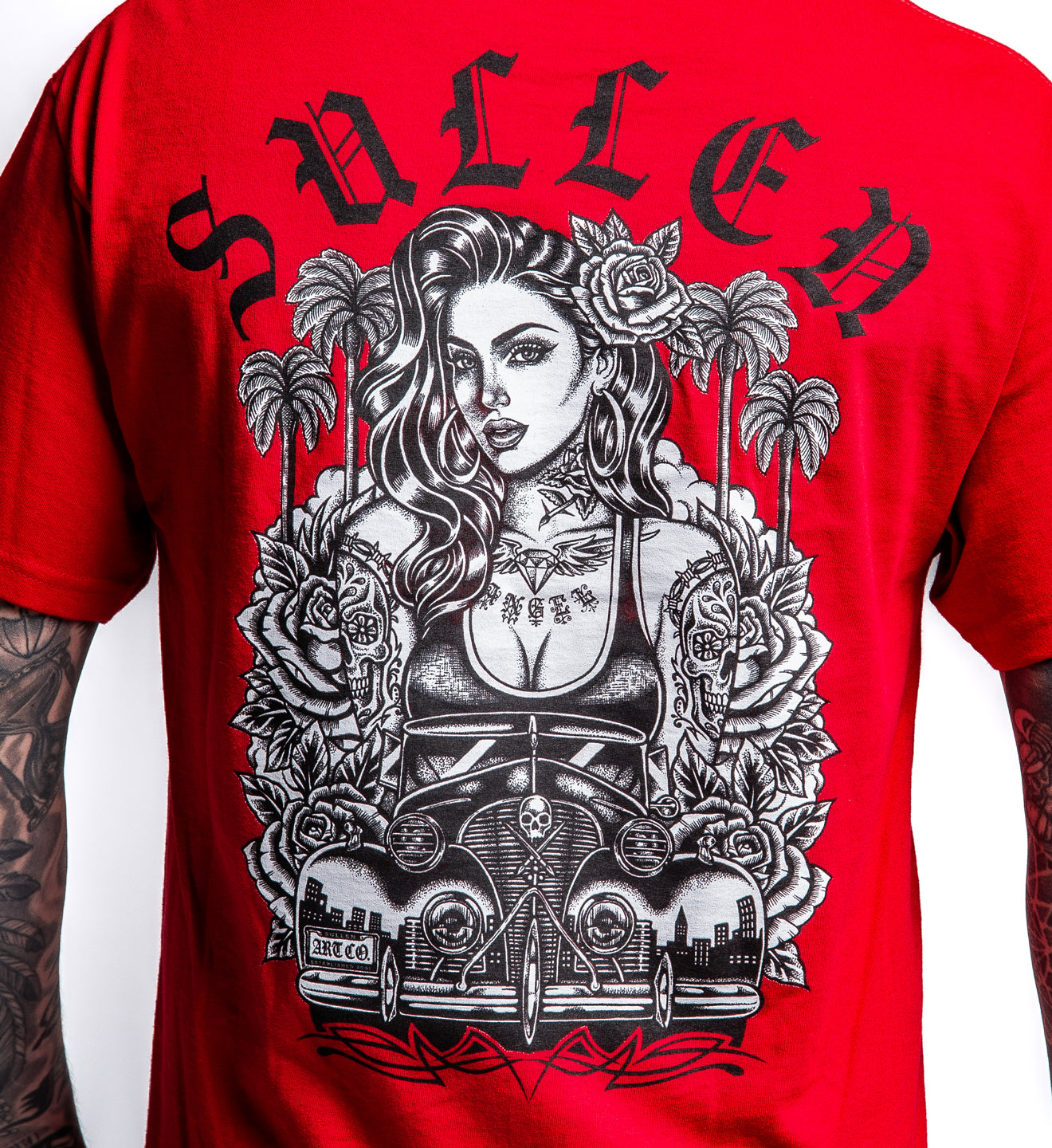 Red t-shirt with a black and white graphic design of a woman, car, and palm trees on the back.