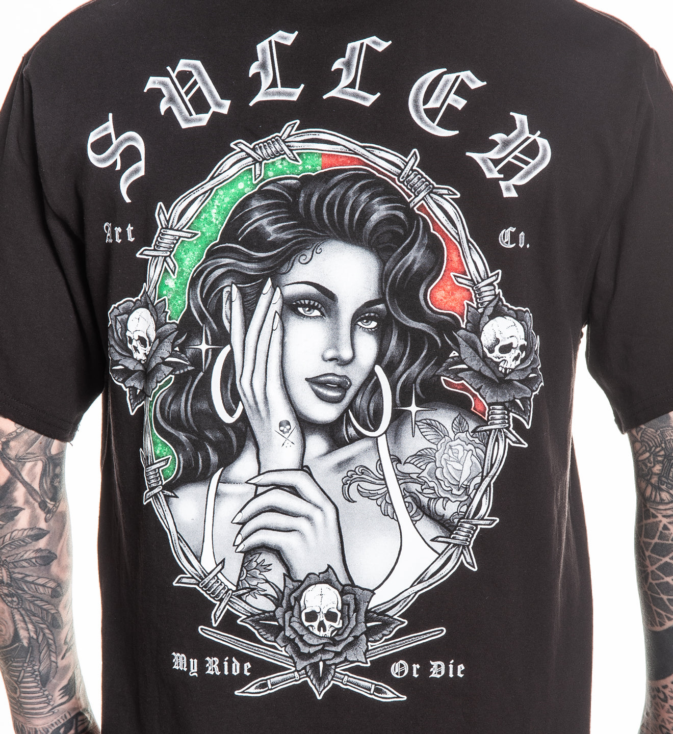 Black t-shirt with a graphic design featuring a woman's face, barbed wire, and skulls on a white background.