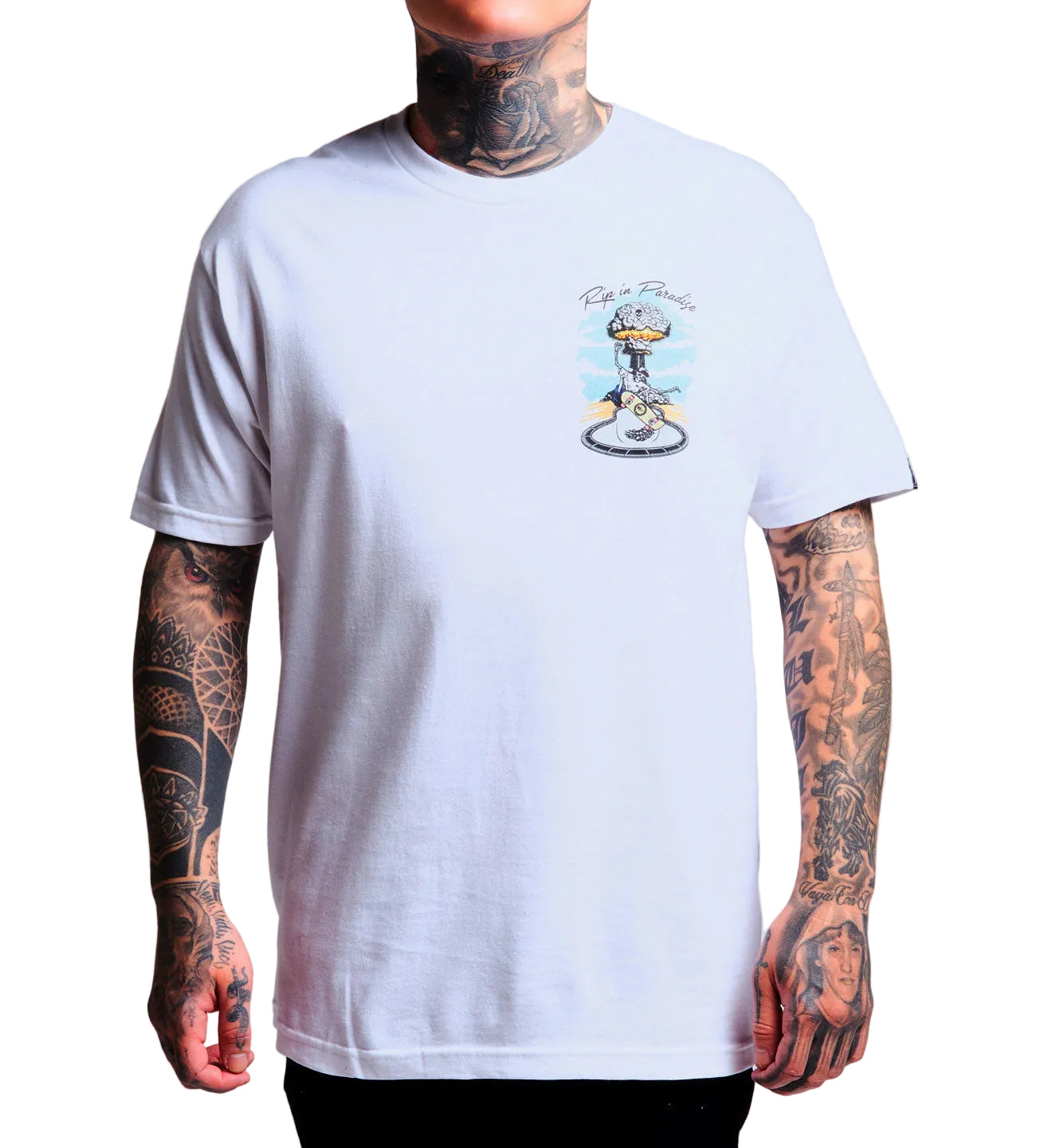 Person wearing a white t-shirt with a graphic design on a plain background