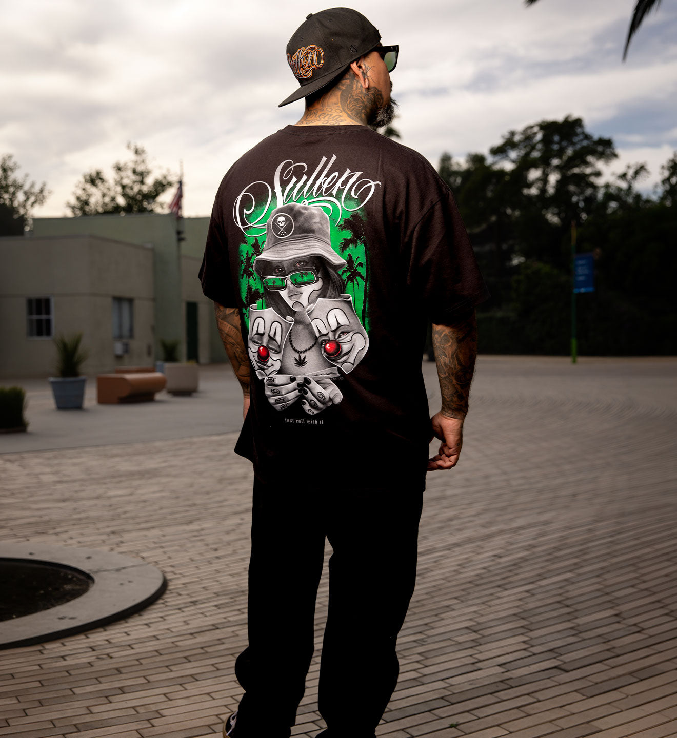 Man wearing a black t-shirt with a graphic design outdoors