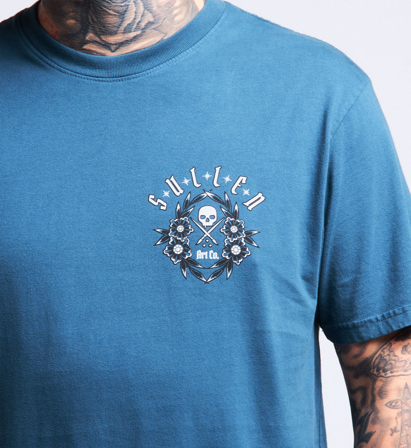 Blue t-shirt with a logo and text on a plain background