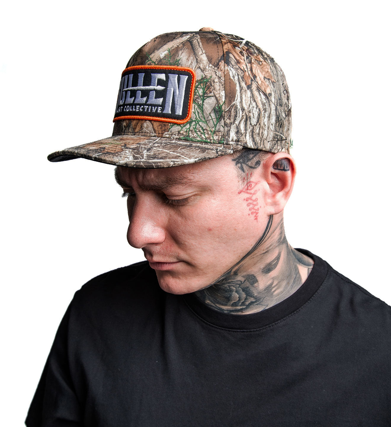 Person wearing a camouflage cap with a brand logo on a white background