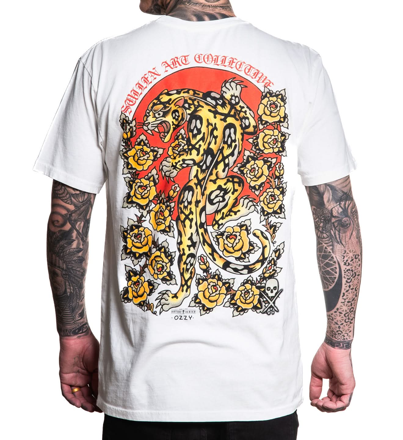 White t-shirt with a colorful panther design on the back, worn by a person with tattoos.
