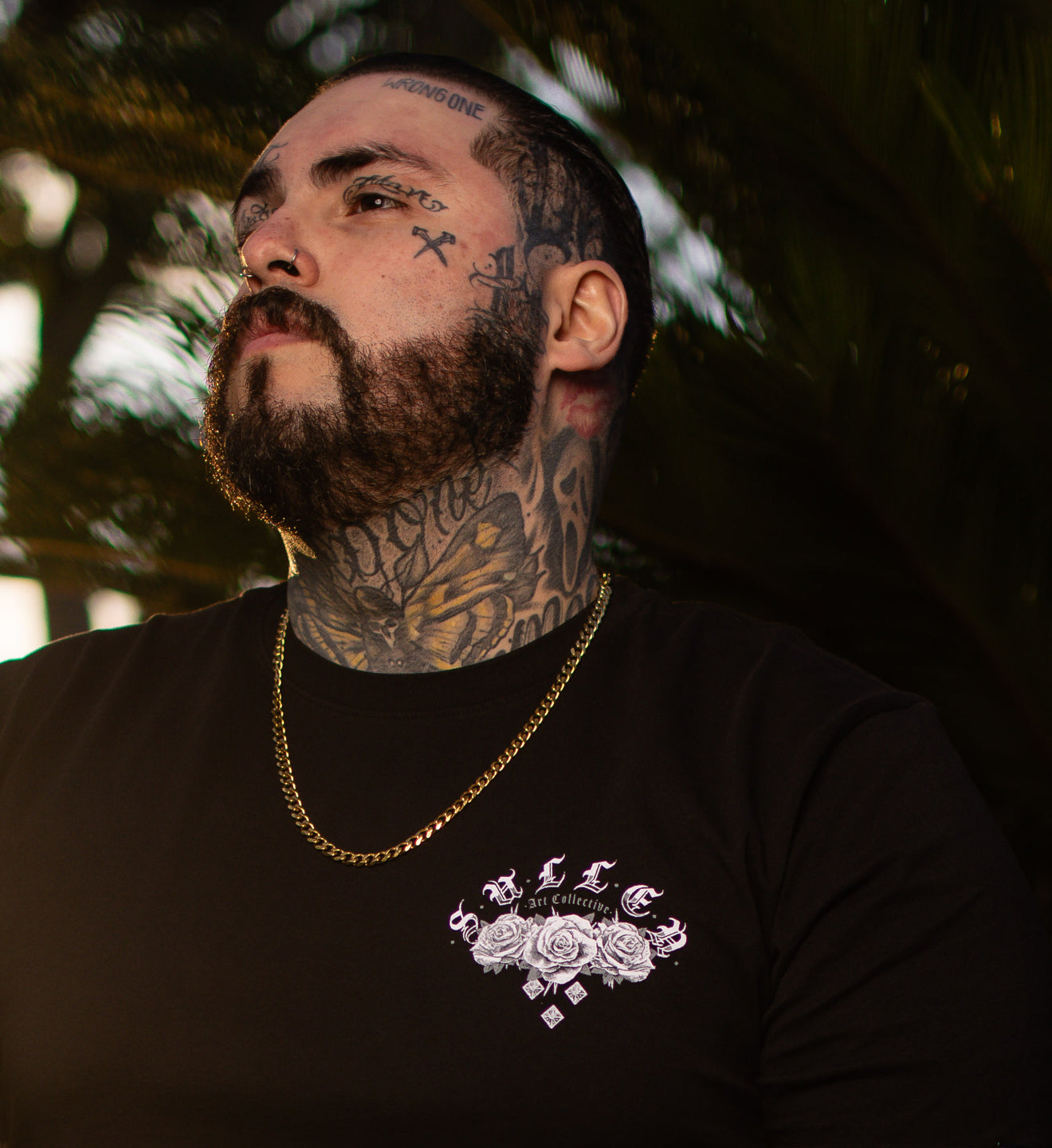 man in a black shirt with a front art print in black and grey roses