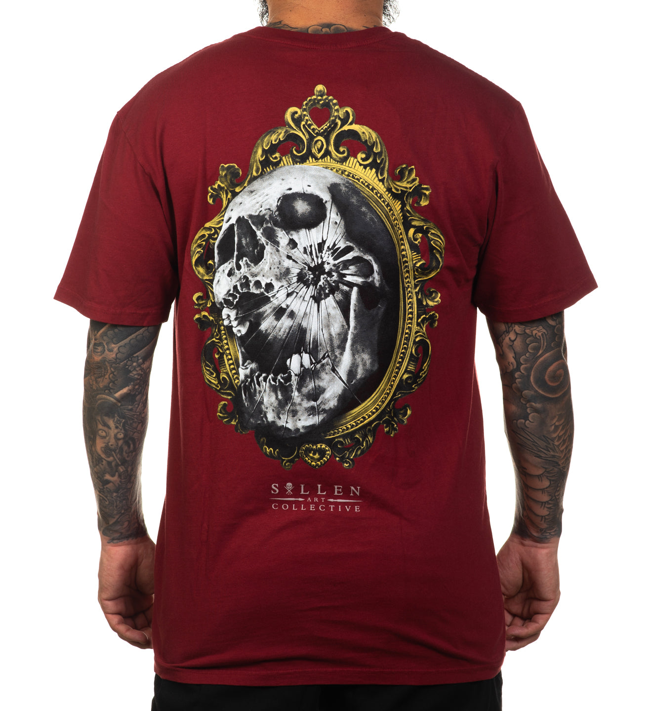 Red t-shirt with skull design on the back, worn by a person with tattoos.