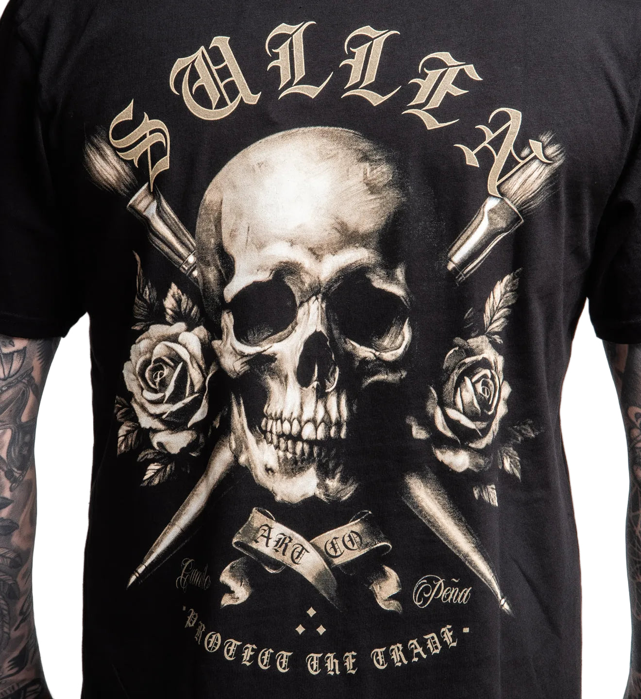 Black t-shirt with a skull and roses design on a plain background