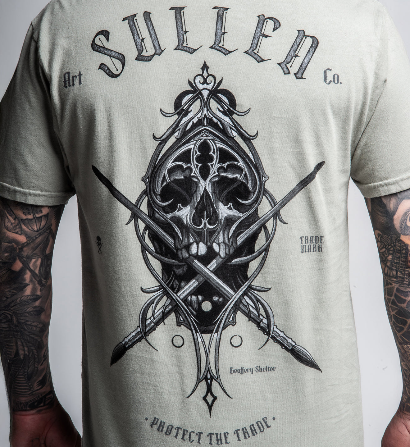 T-shirt with skull and crossbones design and 'Sullen' branding