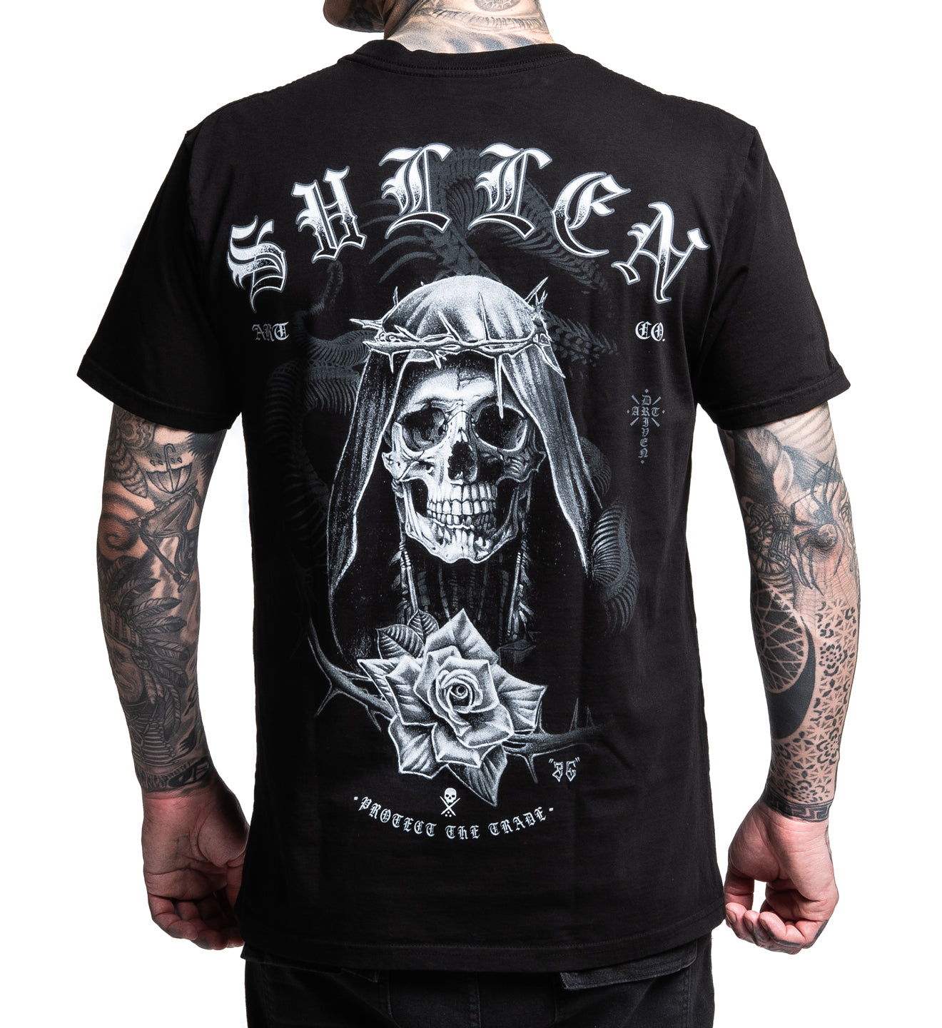 Black t-shirt with a skull and rose design on the back, worn by a person with tattoos.