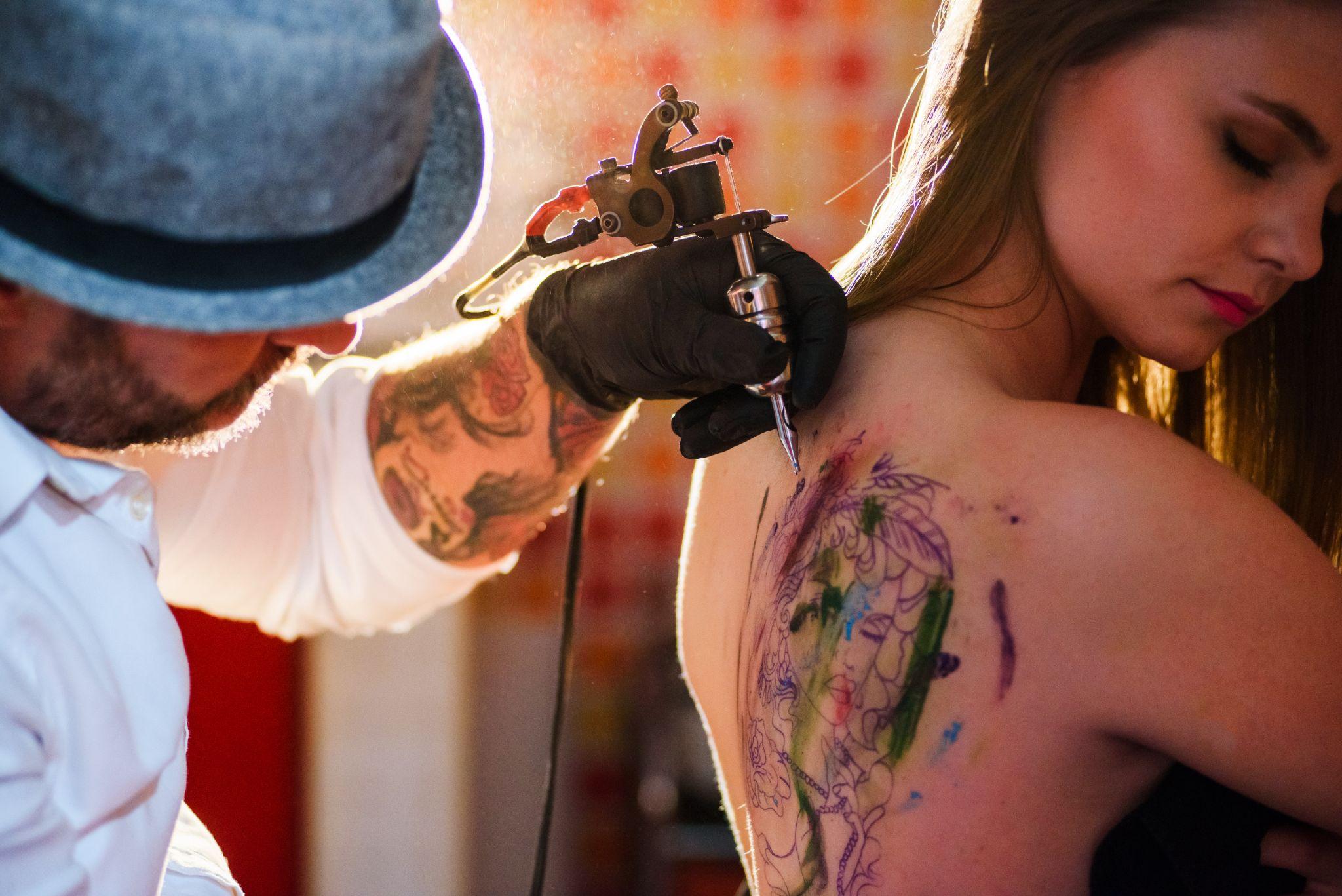 Woman getting a UV reactive tattoo