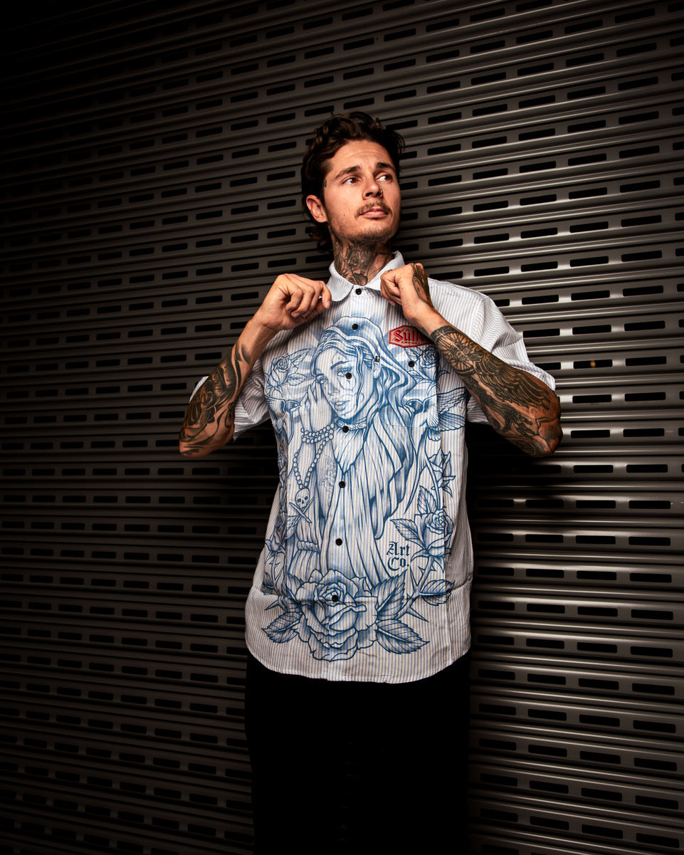 Man with tattoos standing in front of a Las Vegas casino sign