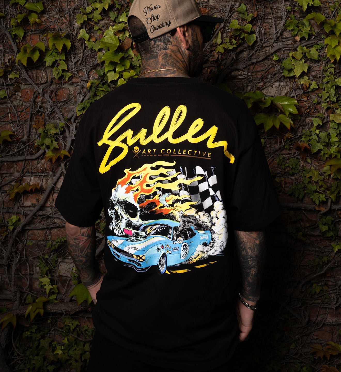Person wearing a black t-shirt with a colorful graphic design and 'Fuller Art Collective' text.
