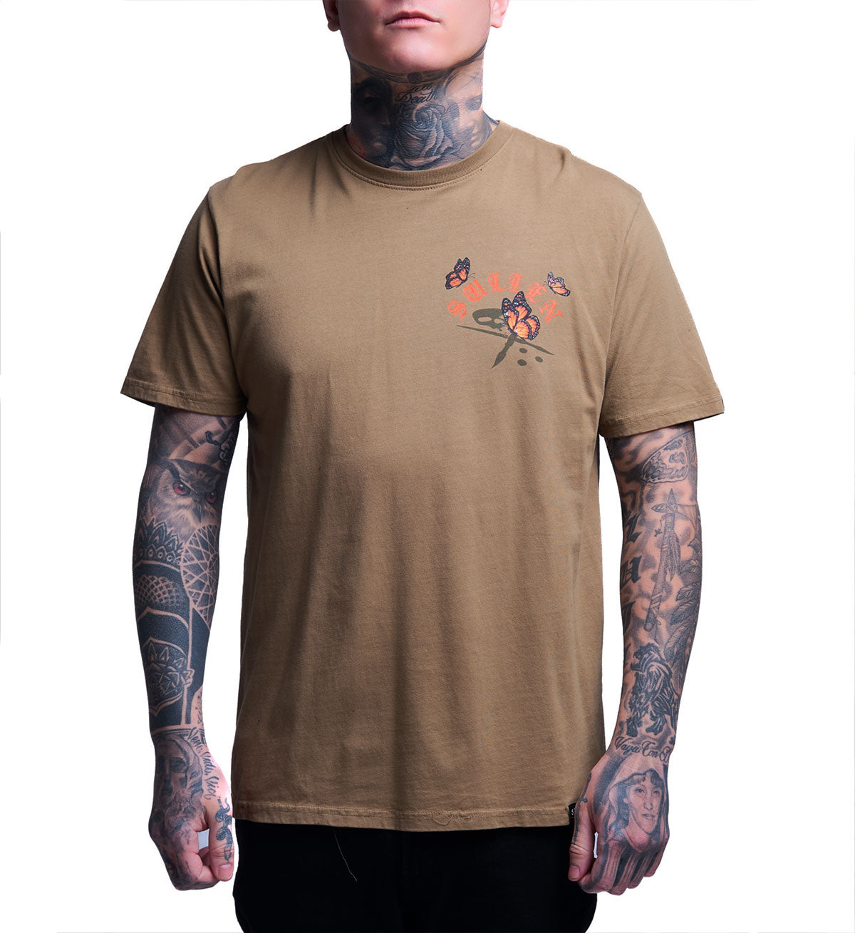 Man wearing a brown t-shirt with a graphic design on a white background