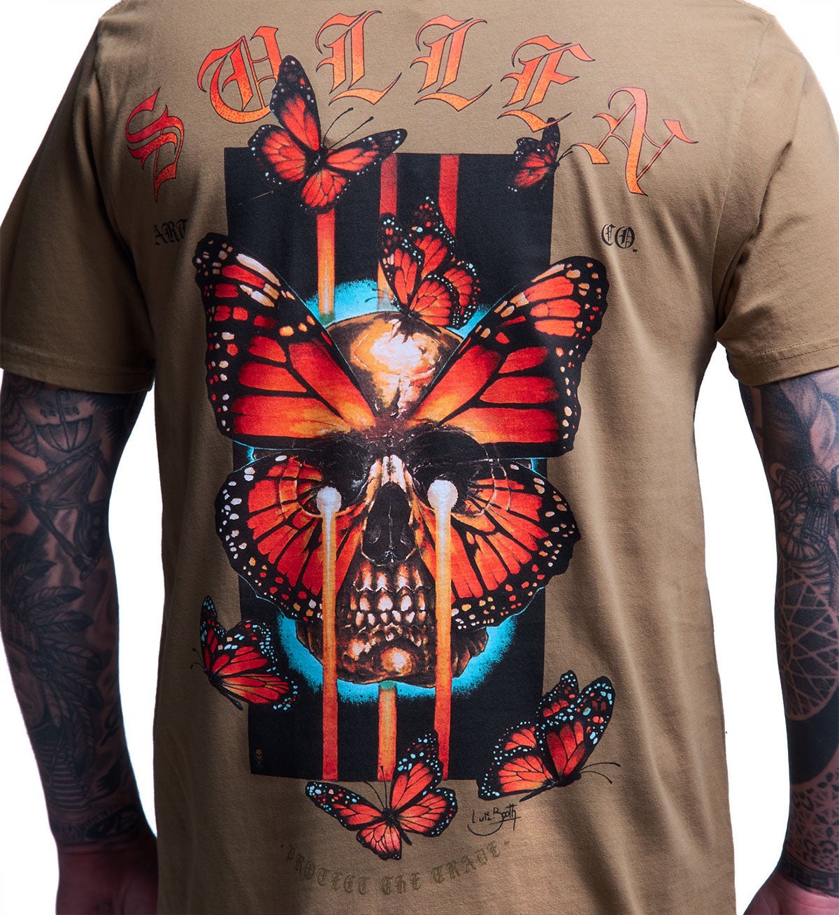 T-shirt with a design of butterflies and a skull on a beige background