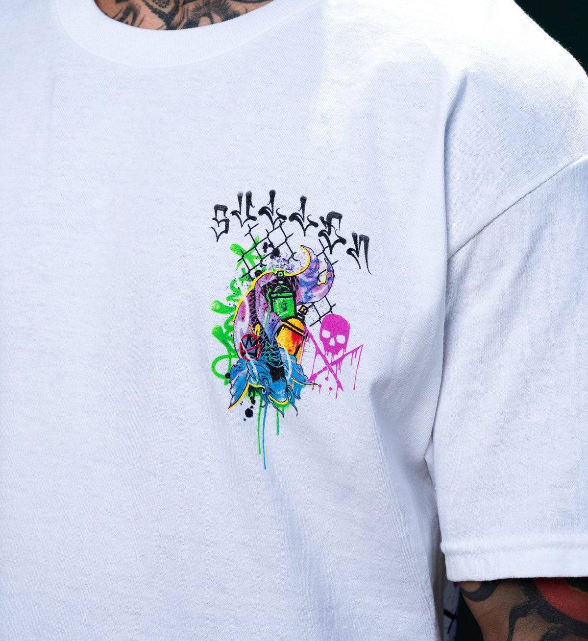 White t-shirt with colorful graphic design on the sleeve