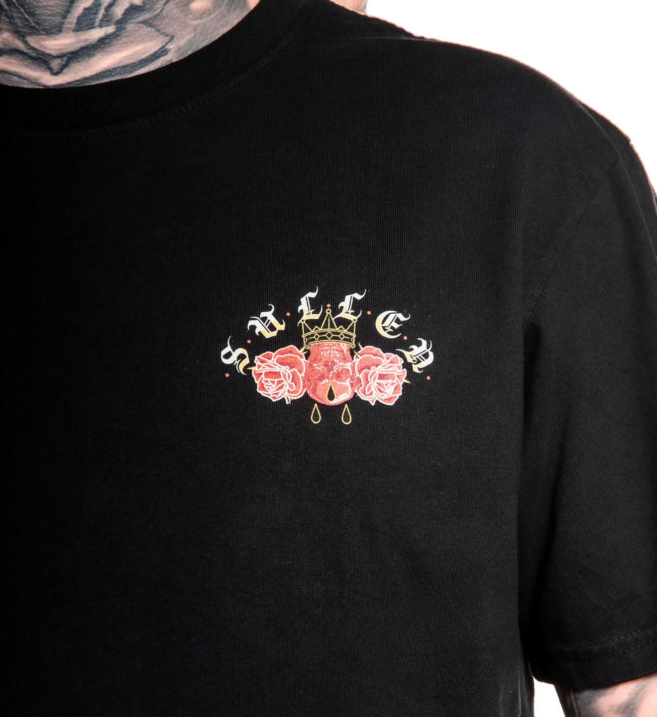 Black t-shirt with a decorative design on the chest featuring roses and a crown.